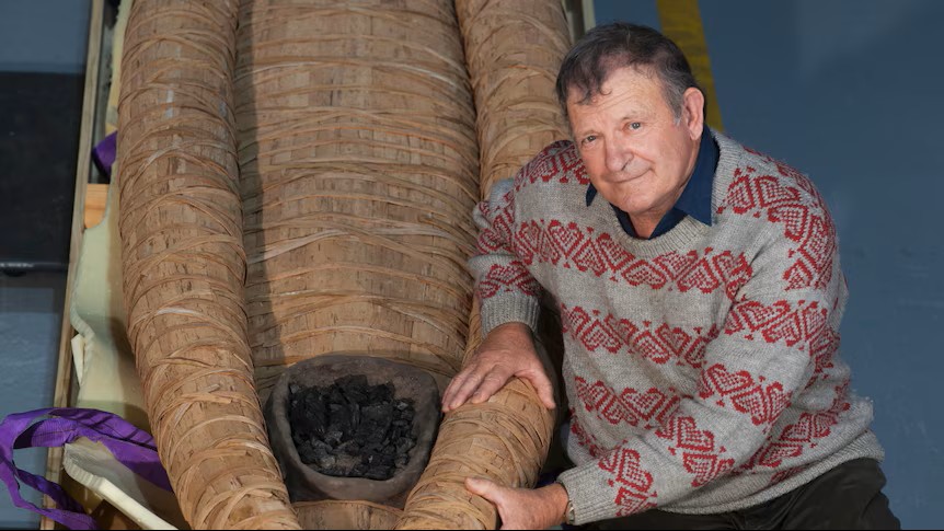 Uncle Rex Greeno with his traditionally made Tasmanian Aboriginal bark canoe