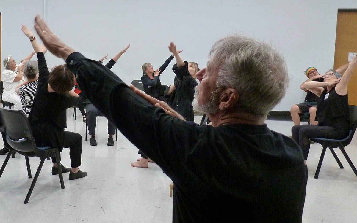 People performing dance while seated