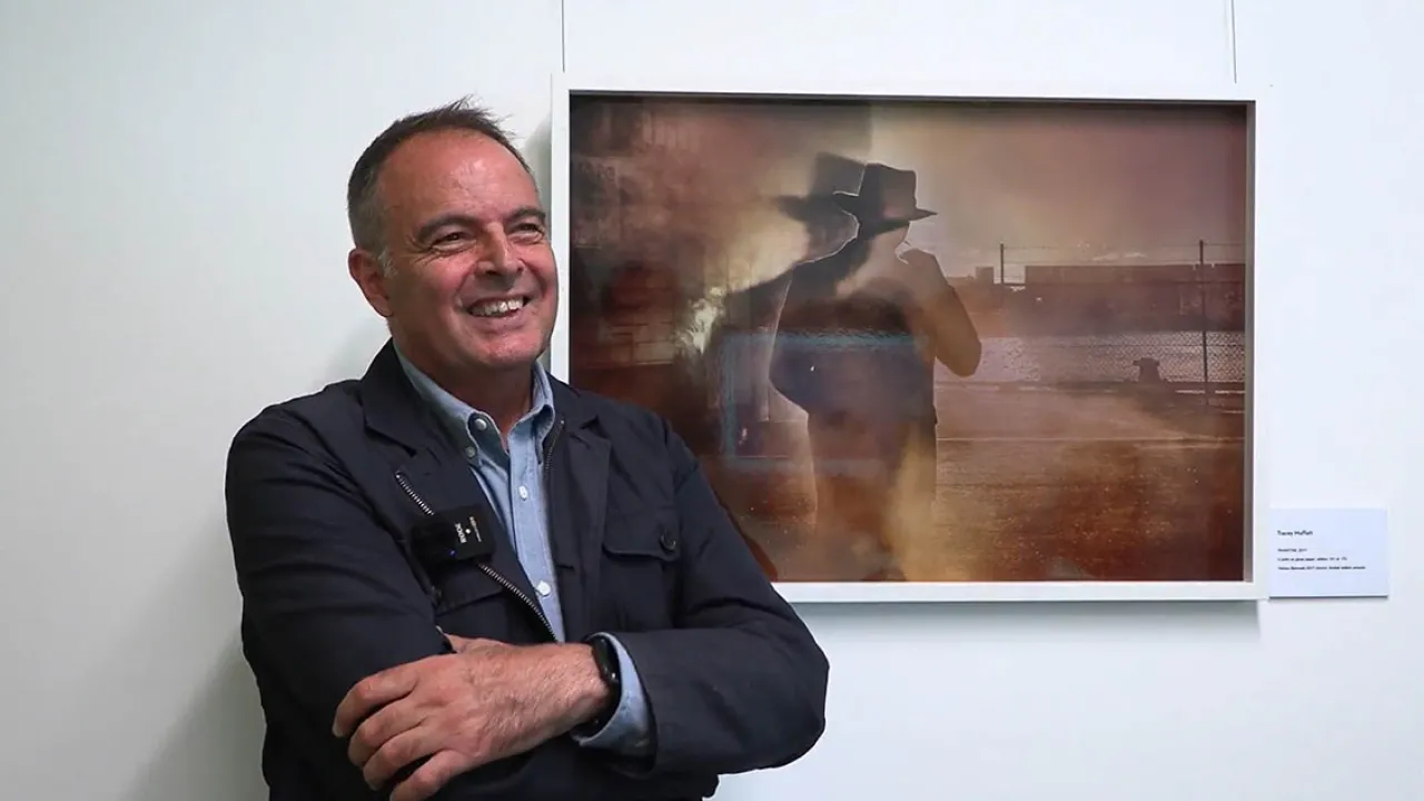 Diego Carpentiero being interviewed in Sydney. Artwork by Tracey Moffat