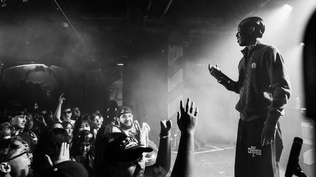 Black and white photo of artist onstage