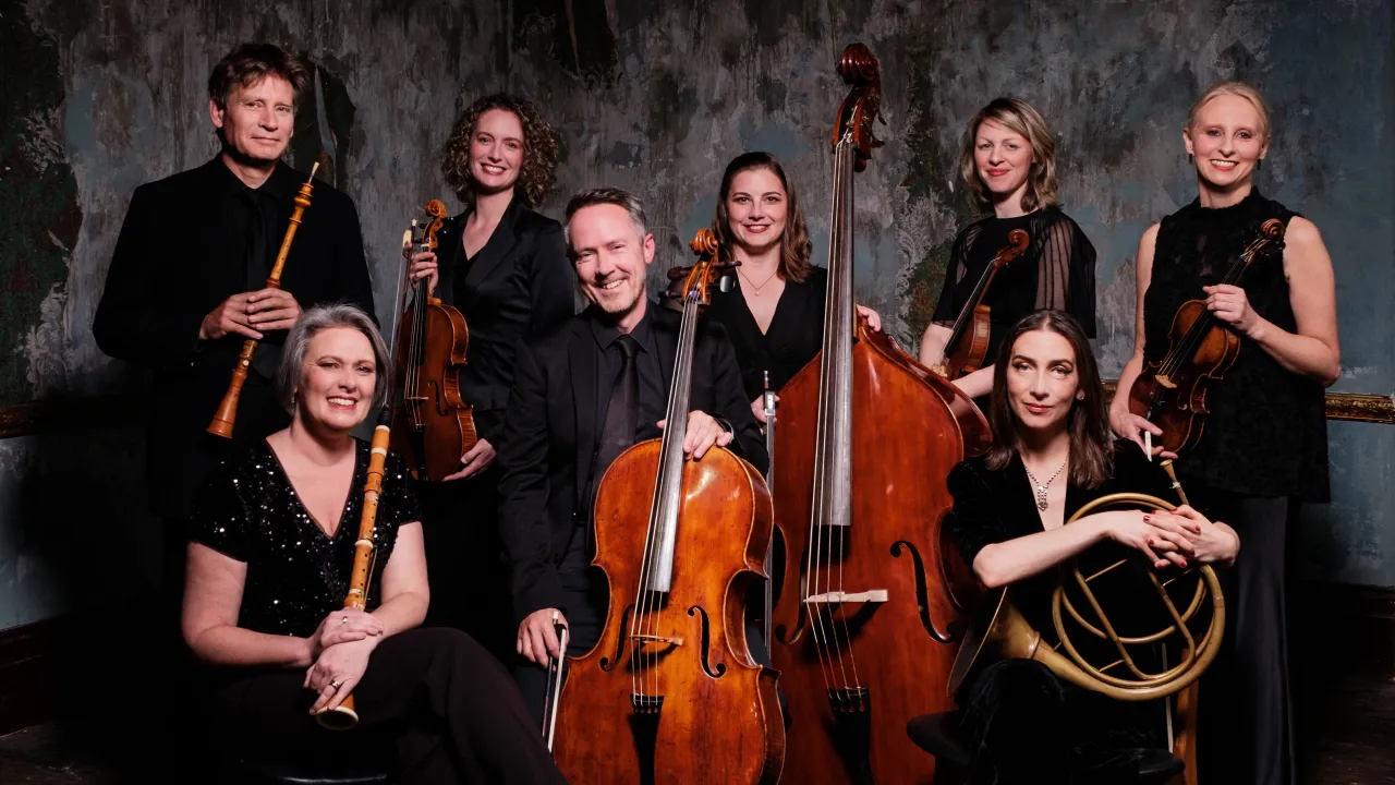 Australian Romantic & Classical Orchestra musicians with instruments on gray background.
