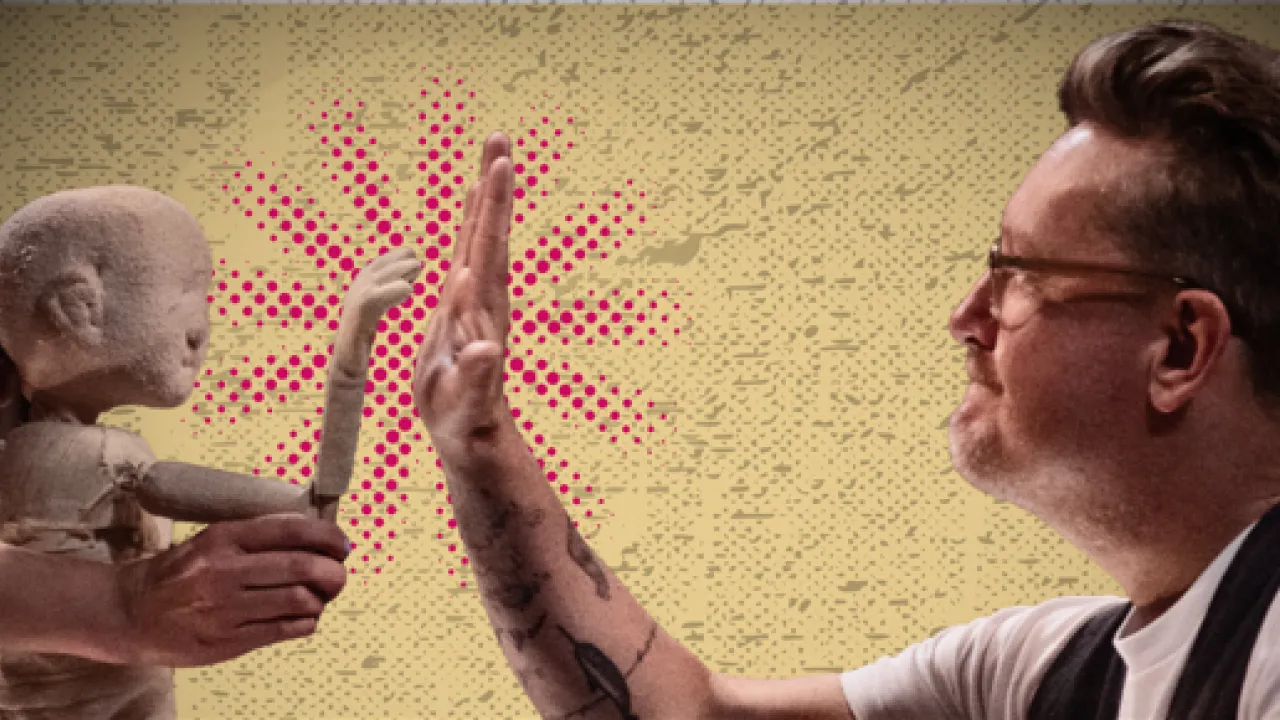 A photograph featuring a puppeteer raising the hand of a puppet to hi-five the hand of a male Artistic Director Andy Packer wearing glasses, a white tshirt and black vest. The overlayed text reads Support Slingsby's Final Act of Wonder.