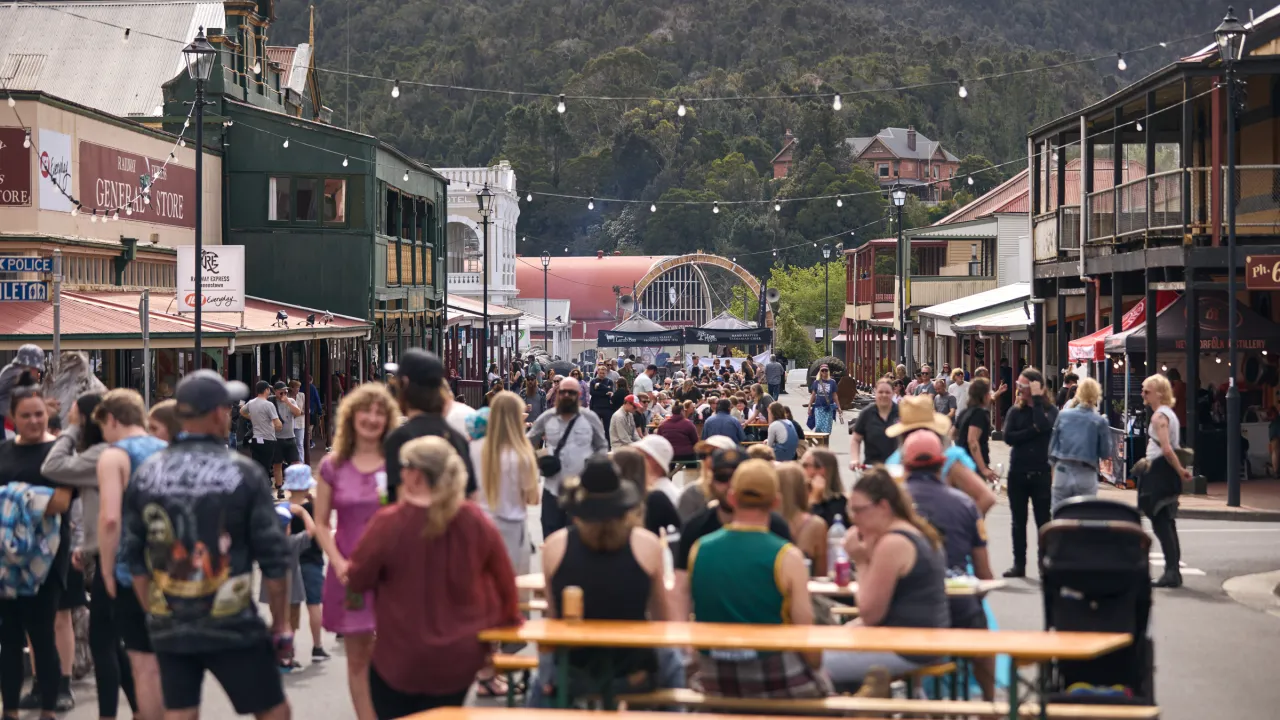 Queenstown's main street full of people, festoon lighting and activity as part of The Unconformity 2023 festival.