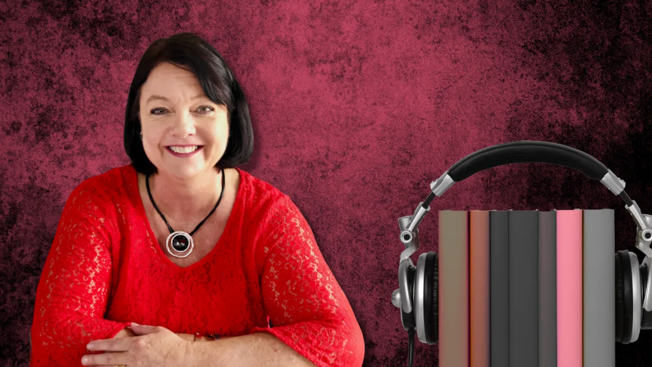 Australian author TM Clark, wearing red, sitting at a desk, with 7 books inside a set of headphones, on a red and black dappled background.