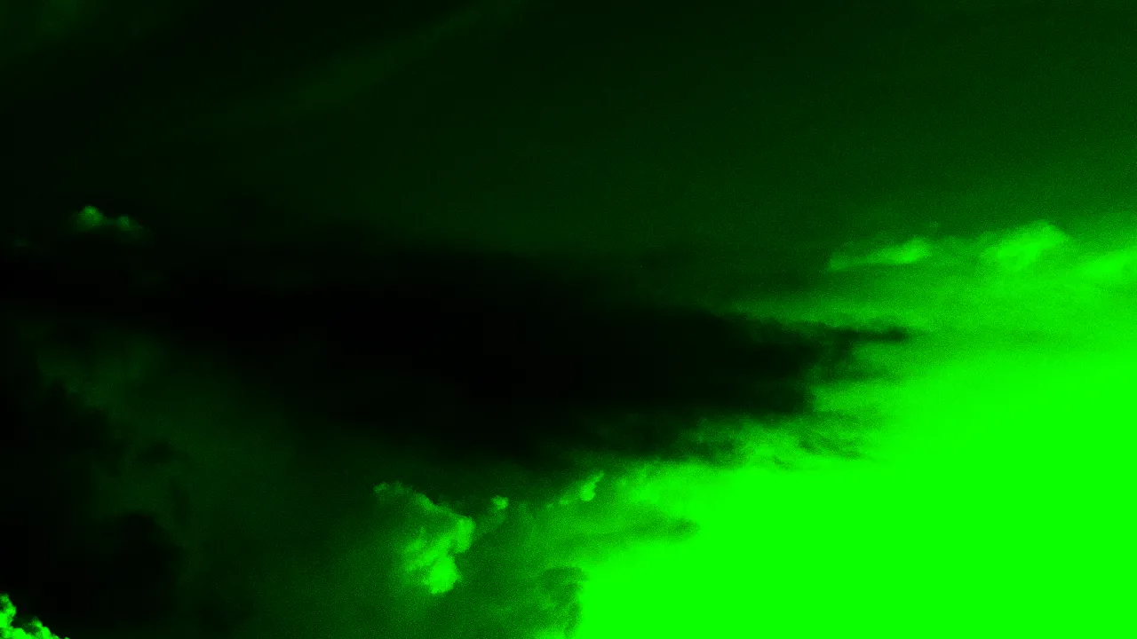 Green and black motif of clouds moving across the sky and a crescent moon