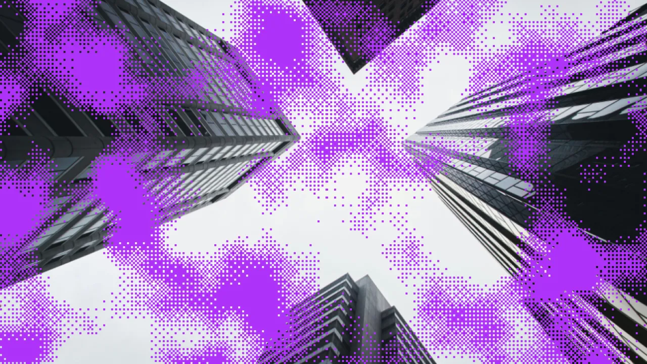 Worms eye view of high rise buildings. The negative space in the sky resembles a cross section and serves as a visual representation of the campaign title 'voices at a crossroads'. The photo has a layer of bright purple pixels across the image.