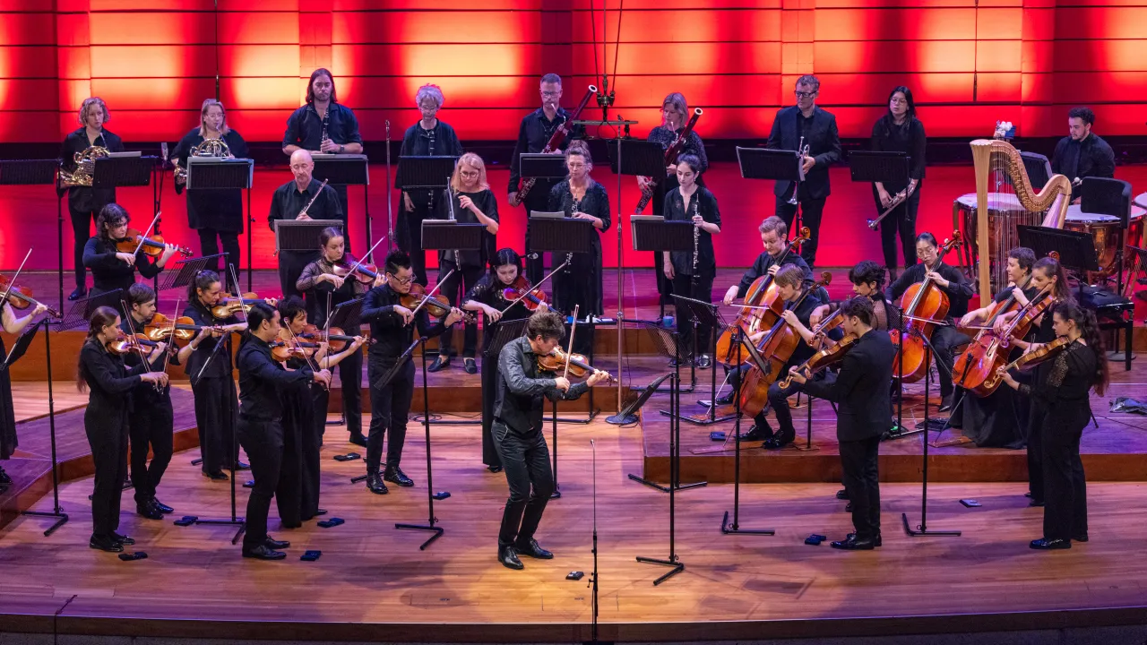 Shot of Camerata - Queensland's Chamber Orchestra performing with violin soloist Brendan Joyce