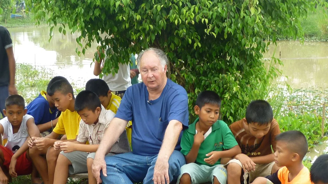 Irish/American Catholic Priest - Father Joe Maier with the children of the largest slum in Bangkok.