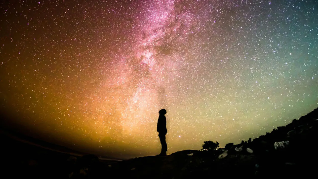 Person's silhouette in front of the Milky Way