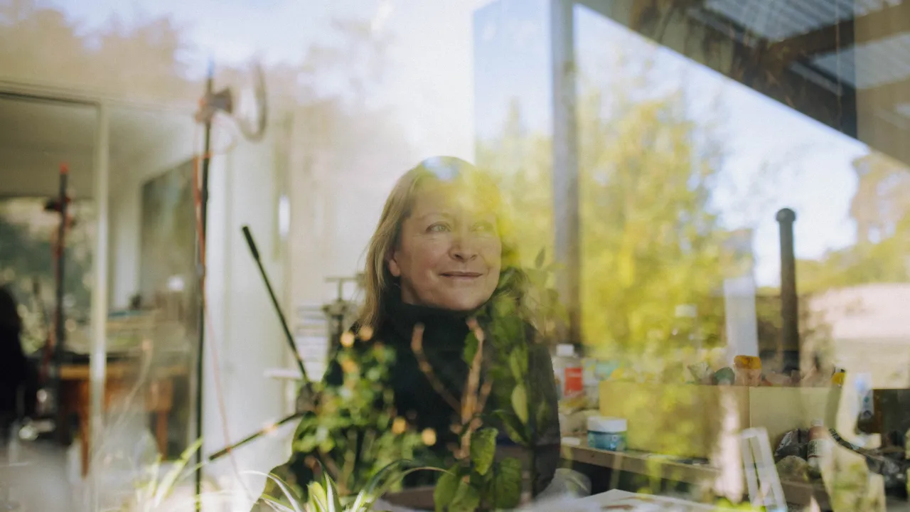 Erica Tandori in her studio through a sunny window