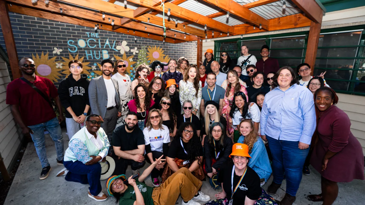 Group shot of around 40 people smiling at the camera