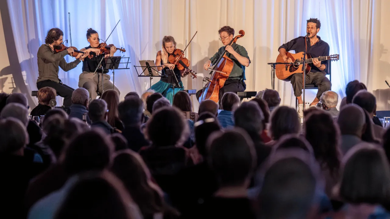 a string quartet accompany singer Lior