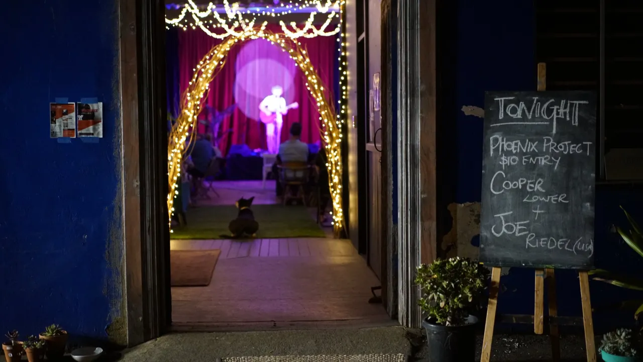 Image looking through the doorway of a country town hall towards a performer in the distance