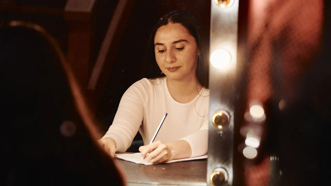 Writer Monikka Eliah making notes in the Green Room, The Vanguard venue