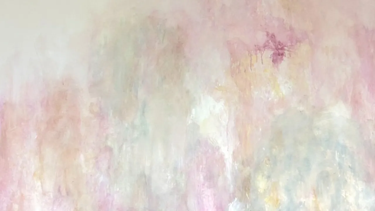 A softly paintes abstract work in shades of pastel pink, green and orange with areas of blank canvas also visible