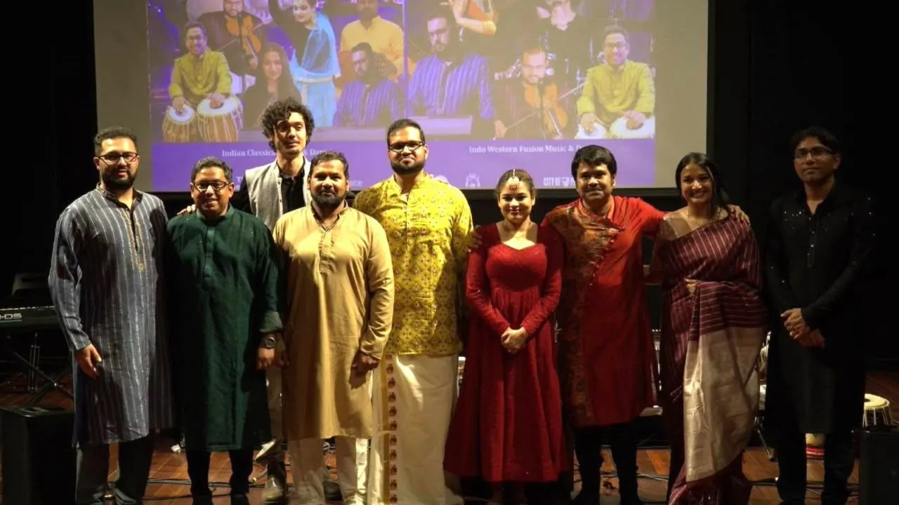 SwaraSynthesis musicians and dancer posing together on stage following a live performance, celebrating contemporary Indian-global music, movement and cultural collaboration.