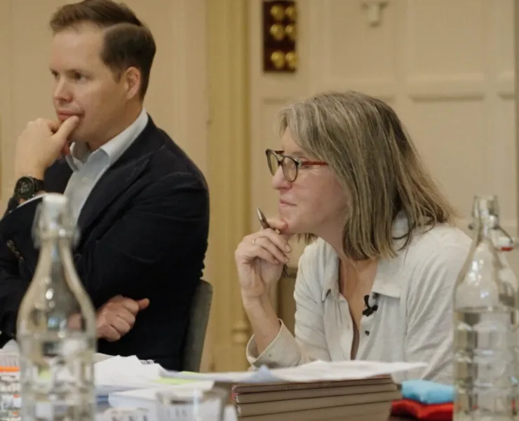 A man and woman at a conference desk