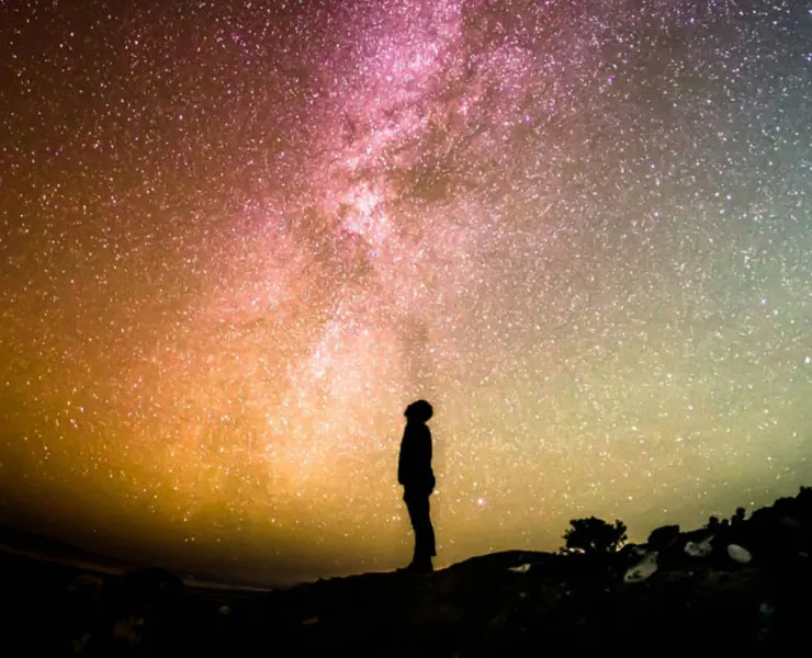 Person's silhouette in front of the Milky Way